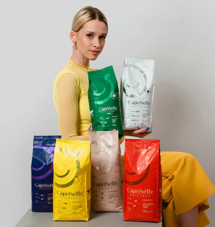 Woman sitting in between bags of Coffee